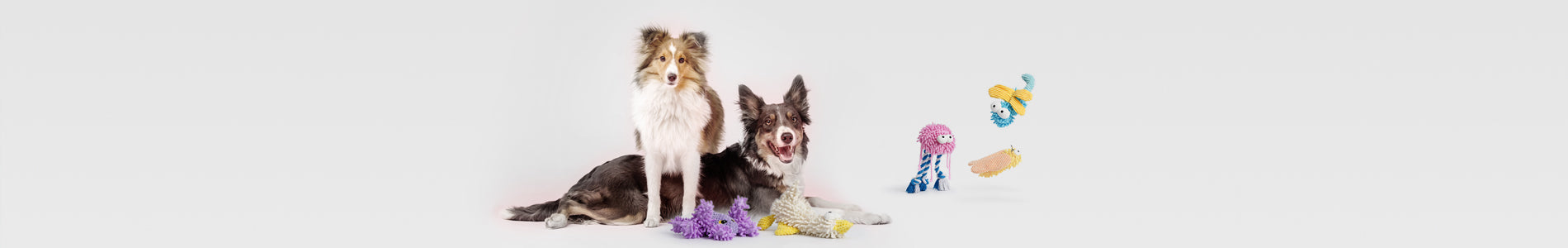 Two large dogs showcasing durable squeaky toys designed for Large Dogs, perfect for tough chewers and active play.